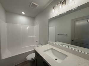 Full bathroom with shower / tub combination, vanity, and a textured ceiling