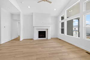Unfurnished living room featuring light wood-style flooring, a fireplace, recessed lighting, and ceiling fan