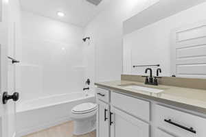 Full bath with shower / washtub combination, vanity, and light tile patterned flooring