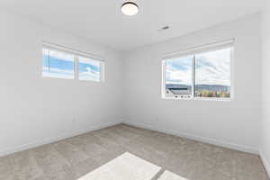 Empty room with carpet flooring and baseboards