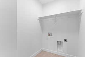 Washroom with light tile patterned floors, washer hookup, and electric dryer hookup