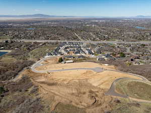 Aerial view of property and surrounding area with nearby suburban area and a water and mountain view