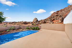 View of pool featuring a fenced backyard and a patio area