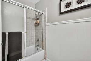 Full bathroom with enclosed tub / shower combo