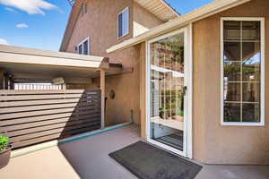 Doorway to property with stucco siding