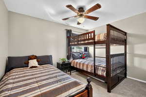 Bedroom featuring light carpet and ceiling fan