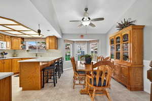 Dining space featuring a ceiling fan and light tile patterned flooring