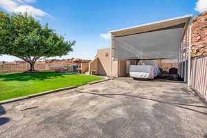 View of parking / parking lot featuring a fenced backyard