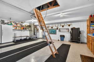 Garage featuring freestanding refrigerator
