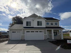 Craftsman house featuring covered porch, concrete driveway, and an attached garage