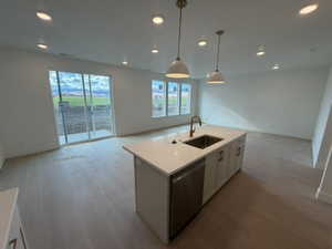 Kitchen featuring open floor plan, recessed lighting, white cabinets, and light wood-style flooring