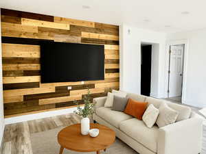 Living area featuring wood finished floors and wood walls