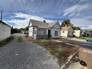 Bungalow-style house with roof with shingles and a chimney
