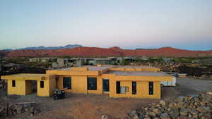 Property at dusk featuring a mountain view