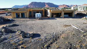 Rear view of house featuring a mountain view and stucco siding