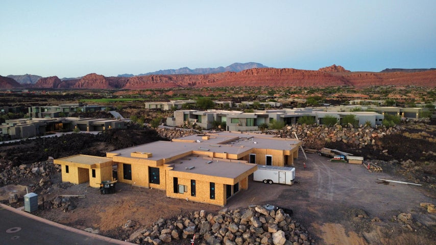 Aerial view of property and surrounding area with a mountain backdrop