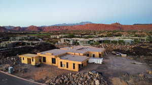 Aerial view of property and surrounding area with a mountain backdrop