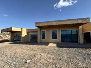 Back of property featuring a patio area and stucco siding