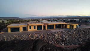 Rear view of property featuring a mountain view and stucco siding