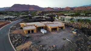 Aerial view of property and surrounding area featuring a mountainous background