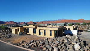 View of front of house with a mountain view and stucco siding