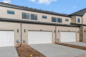 Back of property with concrete driveway