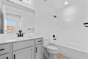 Bathroom with bathing tub / shower combination, light tile patterned floors, and vanity