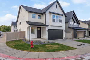 View of front of home with roof with shingles, a porch, an attached garage, concrete driveway, and stucco siding