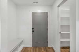 Mudroom featuring wood finished floors and baseboards