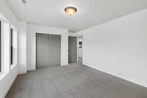 Unfurnished bedroom with carpet floors and a closet
