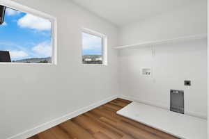 Laundry room featuring dark wood finished floors, washer hookup, hookup for an electric dryer, and a mountain view