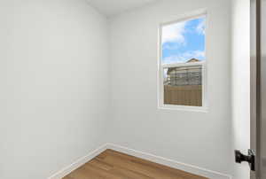 Empty room with baseboards and wood finished floors