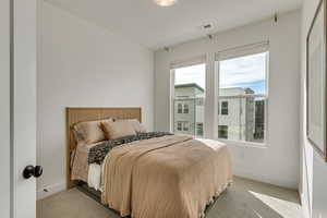 Carpeted bedroom featuring baseboards