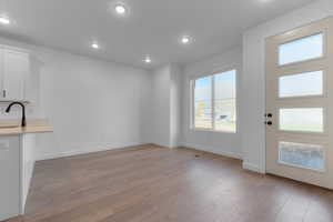 Unfurnished dining area featuring light wood-style floors and recessed lighting
