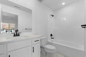 Full bath featuring washtub / shower combination and vanity