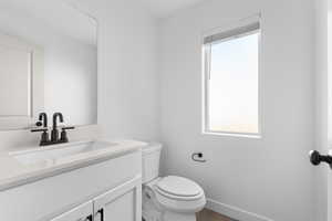 Bathroom with vanity, plenty of natural light, and wood finished floors