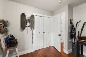 Entryway featuring baseboards and dark wood-style floors