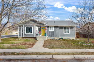 Bungalow-style home featuring roof with shingles