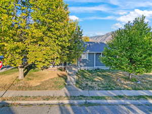 View of front facade with a mountain view and a front yard