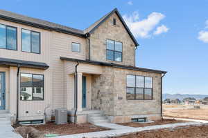 View of front of house featuring stone siding and a mountain view