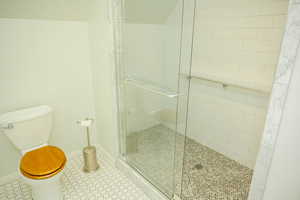 Master bath featuring a shower stall and tile patterned floors