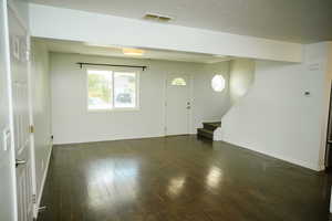 Entrance foyer featuring hand scraped dark wood finished floors and stairway