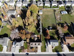 Aerial view of property and surrounding area with nearby suburban area