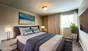 Virtually Staged - Bedroom with baseboards and dark colored carpet