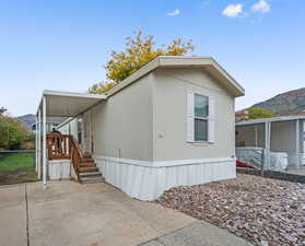 View of front of house featuring a mountain view and a patio area