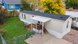 View of front of home featuring a gate and roof with shingles