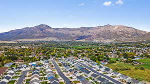 Aerial overview of property's location featuring nearby suburban area and a mountain backdrop