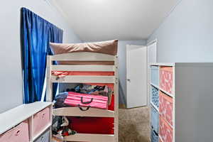 Bedroom featuring light colored carpet