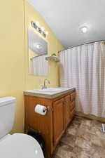 Full bathroom featuring vanity, a textured ceiling, and stone finish flooring