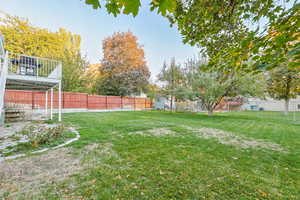 Fenced backyard with a wooden deck